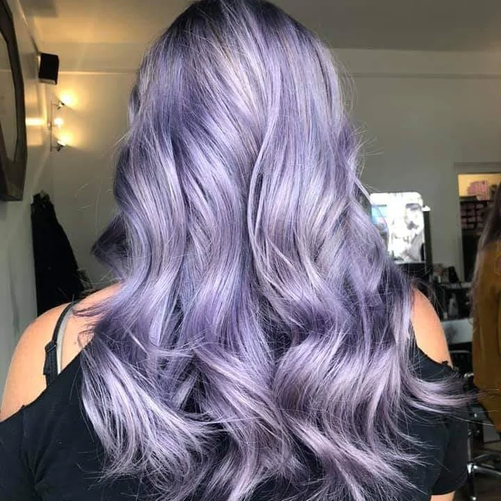 Violet hair colour styled with soft waves at Sam’s salon